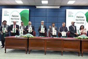 A group photo of Federal Minister for Education Dr. Khalid Maqbool Siddiqui, Secretary Nadeem Mahbub, AIOU Vice Chancellor Dr. Nasir Mahmood, and PIE Director General Dr. Shahid Soroya holding copies of the NFE ASR 2023-24 during the launch of the Annual Pakistan Non-Formal Education Statistical Report at AIOU