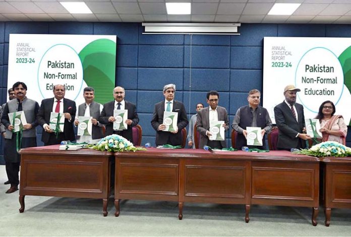 A group photo of Federal Minister for Education Dr. Khalid Maqbool Siddiqui, Secretary Nadeem Mahbub, AIOU Vice Chancellor Dr. Nasir Mahmood, and PIE Director General Dr. Shahid Soroya holding copies of the NFE ASR 2023-24 during the launch of the Annual Pakistan Non-Formal Education Statistical Report at AIOU