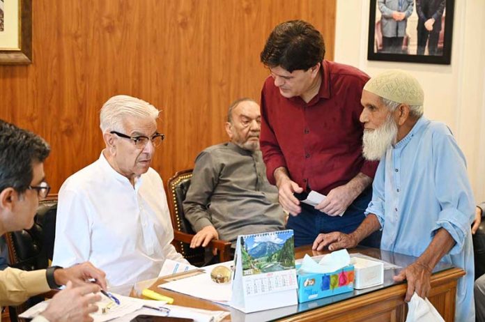 Defense Minister Khawaja Muhammad Asif listens to public concerns during a meeting at his residence
