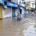 A heavy downpour measuring 97 millimetres disrupts daily life in the city, as roads are inundated with rainwater during the second spell of the monsoon at Tehsil Road Furniture Market in Chiniot