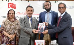 Dr. Furqan Hameed presents his book to Minister for Information and Broadcasting Attaullah Tarar in the presence of H.E. Irfan Naziroğlu, Ambassador of the Republic of Türkiye, during the official launching ceremony of 'Recep Tayyip Erdoğan: The Tiger of the Islamic World – A Leader of Vision, Resolve & Reform' held at the National Language Promotion Department.