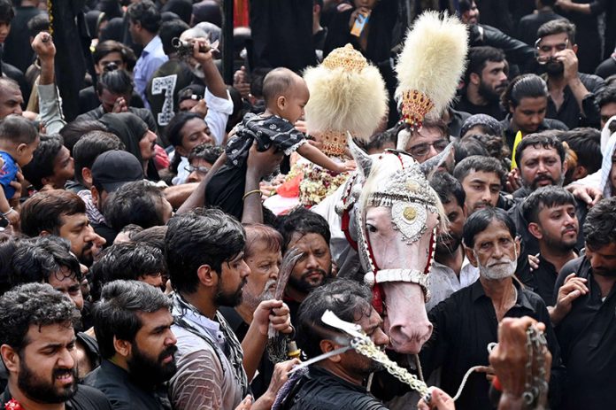 A large number of mourners attending the procession of 9th Muharram-ul-Haram. Muharram ul Harram known as the first month of the Islamic calendar and the mourning month in remembrance of the martyrdom (Shahadat) of Hazrat Imam Hussain (AS), the grandson of the Holy Prophet Mohammad (SAWW)