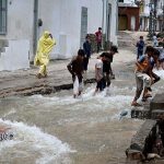 Children enjoy bathing, jumping, and splashing in flooded streets after a torrential downpour in Saidpur Village of the Federal Capital