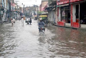 A heavy downpour measuring 97 millimetres disrupts daily life in the city, as roads are inundated with rainwater during the second spell of the monsoon at Tehsil Road Furniture Market in Chiniot