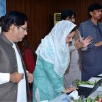 Divisional Commissioner Madam Maryam Khan presses a button on a laptop to announce and release the results of the First Annual Matriculation Examinations during a formal result announcement ceremony at Divisional Model College, Faisalabad