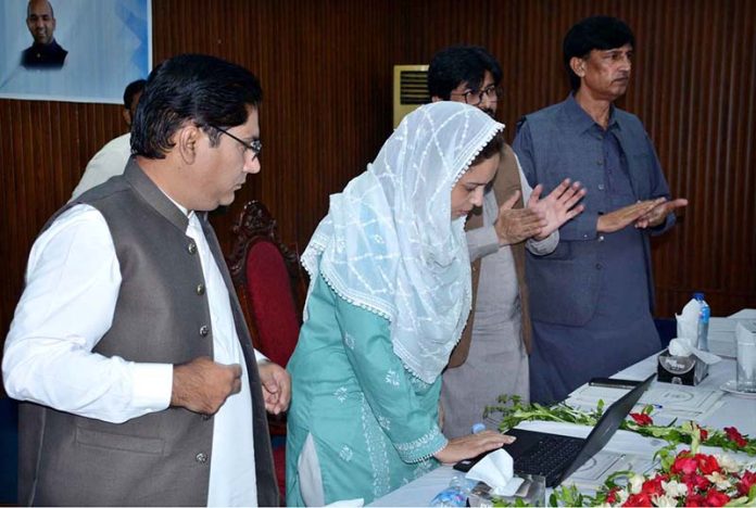 Divisional Commissioner Madam Maryam Khan presses a button on a laptop to announce and release the results of the First Annual Matriculation Examinations during a formal result announcement ceremony at Divisional Model College, Faisalabad