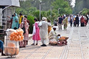 Vendors display edible items to attract visitors outside Faisal Masjid in the Federal Capital