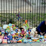 A vendor arranging and displaying the children plastic toys to attract the customers on the footpath at Shera wala