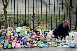 A vendor arranging and displaying the children plastic toys to attract the customers on the footpath at Shera wala