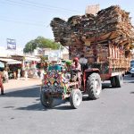 A tractor trolley overloaded with recycle cardboard disrupts traffic flow, highlighting the need for action by traffic authorities
