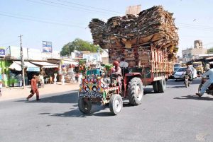 A tractor trolley overloaded with recycle cardboard disrupts traffic flow, highlighting the need for action by traffic authorities