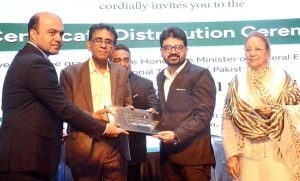 Federal Minister for Education and Professional Training Dr. Khalid Maqbool Siddiqui giving away certificate during a Certificate Distribution Ceremony organized by NAVTTC at Arts Council of Pakistan