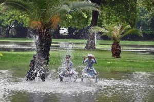 Children enjoying play in rain water at a local park in the provincial capital.