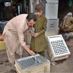 A young boy learns to prepare traditional ice cream (Kulfi) boxes under the guidance of his master amid rising summer demand