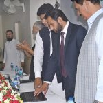 Commissioner Amir Karim Khan, along with Deputy Commissioner Waseem Hamid Sindhu, presses a button to officially launch the 10th class annual results online