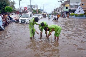 A motorcyclist passes through a flooded area after torrential monsoon rains submerged Jhang Road, Committee Chowk, Furniture Market, and Girls College Road, causing inconvenience to citizens