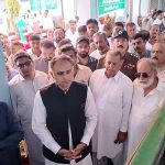 The Minister of State for Finance and Railways, Bilal Azhar Kayani, is being briefed about the damages caused by rain and flash floods in the affected areas of Jhelum