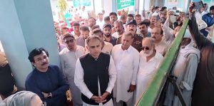 The Minister of State for Finance and Railways, Bilal Azhar Kayani, is being briefed about the damages caused by rain and flash floods in the affected areas of Jhelum