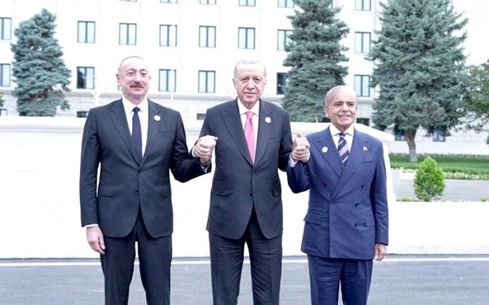 Prime Minister Muhammad Shehbaz Sharif, President of Turkiye Recep Tayyip Erdogan and President of Azerbaijan Ilham Aliyev holding hands in solidarity showing the strong brotherly ties between the three countries after the conclusion of 17th ECO Summit