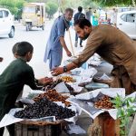 A vendor displays dates at his roadside stall to attract customers