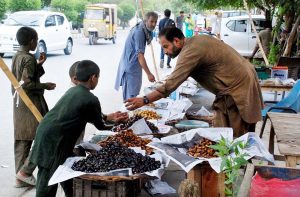 A vendor displays dates at his roadside stall to attract customers
