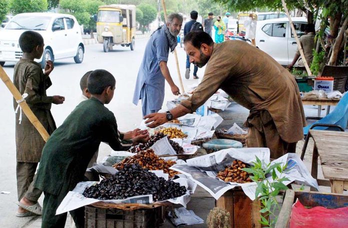 A vendor displays dates at his roadside stall to attract customers