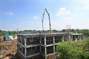 Labourers busy in construction work of the EV bus charging depot near Zero Point, part of infrastructure development for electric public transport.