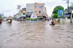 A motorcyclist passes through a flooded area after torrential monsoon rains submerged Jhang Road, Committee Chowk, Furniture Market, and Girls College Road, causing inconvenience to citizens