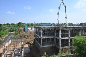 Labourers busy in construction work of the EV bus charging depot near Zero Point, part of infrastructure development for electric public transport.