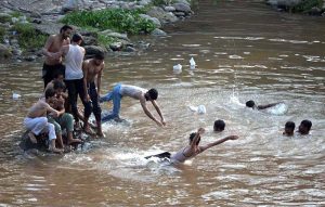 Youngsters swimming in Rawal Lake Spillway stream to get relief of the hot humid weather in the federal capital. The district administration has imposed section 144 due to heavy rain spell and risk of flood in the streams