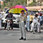 A traffic police officer shields himself with an umbrella while on duty at Inscumb Road,Quetta braving the intense summer heat to ensure smooth traffic flow.