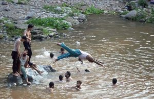 Youngsters swimming in Rawal Lake Spillway stream to get relief of the hot humid weather in the federal capital. The district administration has imposed section 144 due to heavy rain spell and risk of flood in the streams
