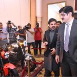 Sindh Chief Minister Syed Murad Ali Shah alongside Minister of Energy Nasir Shah explores the electric bikes showcased at the Sindh's Energy Diversity Conference held at a local hotel
