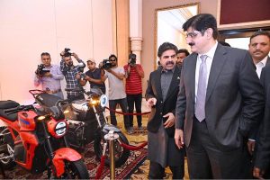 Sindh Chief Minister Syed Murad Ali Shah alongside Minister of Energy Nasir Shah explores the electric bikes showcased at the Sindh's Energy Diversity Conference held at a local hotel