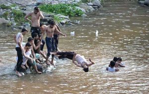 Youngsters swimming in Rawal Lake Spillway stream to get relief of the hot humid weather in the federal capital. The district administration has imposed section 144 due to heavy rain spell and risk of flood in the streams