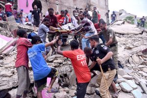 A body is being retrieved from the debris of a collapsed residential building in Baghdadi, Lyari. Rescue workers continue their efforts amid scenes of devastation and despair