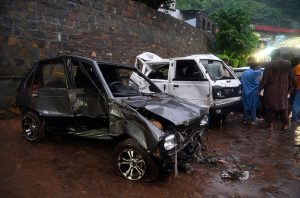 A view of damaged cars being recovered from a nullah in Saidpur Village due to flooding caused by heavy rainfall in the Federal Capital.