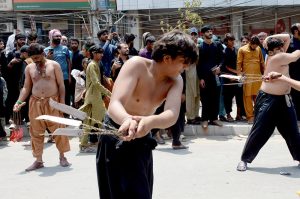 A large number of people beating themselves with chained Knives in a mourning procession of 9th Muharam ul Harm to commemorate the martyrdom of Hazrat Imam Hussain (RA), the grandson of Prophet Muhammad (PBUH) at Mumtazabad