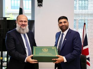 Federal Minister for Commerce Jam Kamal Khan presents a souvenir to UK Minister Lord Wajid Khan during their meeting in London — the two discussed enhancing bilateral trade, investment, and cooperation in urban development.