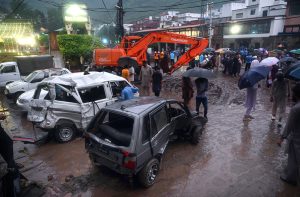 A view of damaged cars being recovered from a nullah in Saidpur Village due to flooding caused by heavy rainfall in the Federal Capital.