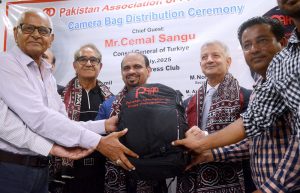 Turkish Counsel General Cemal Sangu addresses the bag distribution ceremony organized by the Pakistan Association of Press Photographers (PAPP) at the Karachi Press Club.