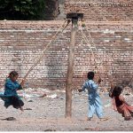 PESHAWAR: July 18 – Street children enjoy a swing ride by the roadside near Ring Road, making the most of a simple moment of joy.