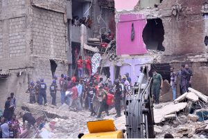 Heavy machinery is deployed for rescue operations after a residential building collapsed in Baghdadi, Lyari. Several people are feared dead and injured