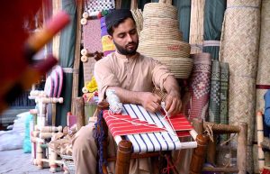 Youngster busy in weaving stool seat at his workplace at Dabgari area.