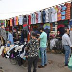 People purchasing second hand Shirts trouser and other clothes at vendors roadside setup in the City.