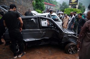 A view of damaged cars being recovered from a nullah in Saidpur Village due to flooding caused by heavy rainfall in the Federal Capital.