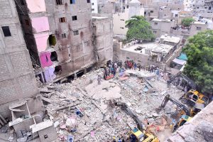 Heavy machinery is deployed for rescue operations after a residential building collapsed in Baghdadi, Lyari. Several people are feared dead and injured