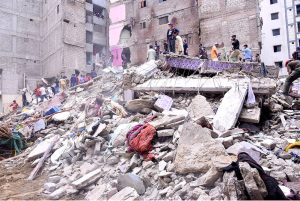 Heavy machinery is deployed for rescue operations after a residential building collapsed in Baghdadi, Lyari. Several people are feared dead and injured