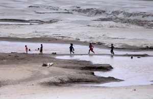 Children play without fearing the threat of floods on the banks of the Indus River near Jamshoro