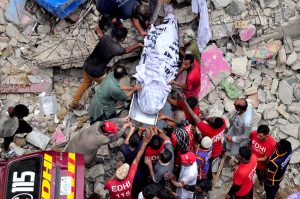 Heavy machinery is deployed for rescue operations after a residential building collapsed in Baghdadi, Lyari. Several people are feared dead and injured